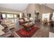 Open-concept living room with hardwood floors, comfortable seating, and lots of natural light at 11 Line Creek Cir, Sharpsburg, GA 30277
