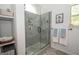 Beautiful glass enclosed shower with tiled walls and base, shelving niches and matte black hardware at 11 Line Creek Cir, Sharpsburg, GA 30277
