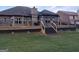 Spacious back deck with stairs leading to the yard, including a metal pergola for outdoor enjoyment at 1128 Carillon Se Dr, Conyers, GA 30013