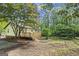 This home features a spacious backyard, a wooden deck, and is surrounded by mature trees at 2687 Fairfield Sw Dr, Marietta, GA 30064