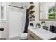 Bathroom featuring a walk-in shower, stylish vanity, modern fixtures, and decorative shelving at 2687 Fairfield Sw Dr, Marietta, GA 30064