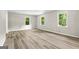 Bright bedroom featuring wood floors, natural light from three windows at 2687 Fairfield Sw Dr, Marietta, GA 30064
