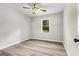 This bedroom features a ceiling fan, light gray walls, wood-look floors, and a window offering natural light at 2687 Fairfield Sw Dr, Marietta, GA 30064