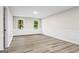 Spacious bedroom with wood floors, two windows, and neutral paint at 2687 Fairfield Sw Dr, Marietta, GA 30064
