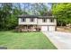 Charming two-story home featuring a well-manicured lawn and attached two-car garage at 2687 Fairfield Sw Dr, Marietta, GA 30064