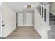 Hallway with wood floors, staircase, and access to other rooms at 2687 Fairfield Sw Dr, Marietta, GA 30064