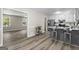 Open-concept kitchen with island, stainless steel appliances, and wood-look floors flowing into the living area at 2687 Fairfield Sw Dr, Marietta, GA 30064