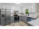 Modern kitchen with stainless steel refrigerator, gray cabinets, quartz countertops, and stainless steel appliances at 2687 Fairfield Sw Dr, Marietta, GA 30064