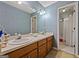 Charming bathroom features floral wallpaper, double sinks, and a shower/tub combo for convenience and relaxation at 2810 Jodeco Ter, Jonesboro, GA 30236