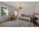 Bedroom with neutral walls, lots of natural light from two windows, as well as a chandelier at 2810 Jodeco Ter, Jonesboro, GA 30236