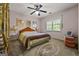Cozy bedroom with ceiling fan, rug, and two lamps on either side of the bed, with a window to let in natural light at 2810 Jodeco Ter, Jonesboro, GA 30236
