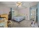 Cozy carpeted bedroom with neutral walls, a ceiling fan, multiple mirrors, and access to an upstairs hallway at 2810 Jodeco Ter, Jonesboro, GA 30236
