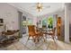 Light-filled breakfast area features wicker seating, tile flooring, a ceiling fan, and views of the backyard at 2810 Jodeco Ter, Jonesboro, GA 30236