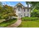 Two-story home featuring a manicured front lawn, mature landscaping, and a grand, columned entrance at 2810 Jodeco Ter, Jonesboro, GA 30236