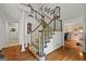 Foyer with wooden floors, staircase, white molding, and wood railing detail at 2810 Jodeco Ter, Jonesboro, GA 30236