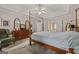 Well-lit bedroom with carpet, a four-poster bed, and seamless access to the primary bathroom at 2810 Jodeco Ter, Jonesboro, GA 30236