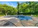 Outdoor pool area featuring a covered pool, stone accents, lounge chairs, and lush landscaping at 2810 Jodeco Ter, Jonesboro, GA 30236
