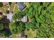 Aerial view of a home with a well-maintained roof, nestled among green trees at 11203 Hemlock Rd, Hampton, GA 30228
