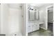 This bathroom features shower, marble countertop vanity, sink and a white cabinet at 11203 Hemlock Rd, Hampton, GA 30228
