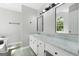 Bright bathroom featuring double vanity with marble countertop and modern lighting fixtures at 11203 Hemlock Rd, Hampton, GA 30228