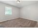 Bright bedroom with neutral walls, plush carpet, and window bringing in natural light at 11203 Hemlock Rd, Hampton, GA 30228