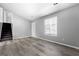 Bedroom with fresh gray paint, wood-look flooring, and a staircase to the second level at 11203 Hemlock Rd, Hampton, GA 30228