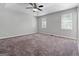 Empty carpeted bedroom with tray ceiling, two windows, and neutral walls at 11203 Hemlock Rd, Hampton, GA 30228