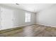 Bedroom with fresh gray paint, wood-look flooring, and natural light streaming through the window at 11203 Hemlock Rd, Hampton, GA 30228