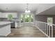 Charming dining area showcases a bay window, wood floors, and a stylish chandelier above at 11203 Hemlock Rd, Hampton, GA 30228