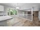 Bright dining area features wood floors, bay window, chandelier, and open floor plan to living space at 11203 Hemlock Rd, Hampton, GA 30228