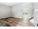 Open-concept living room featuring wood-look flooring, fresh grey paint, and staircase to second level at 11203 Hemlock Rd, Hampton, GA 30228
