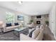 Cozy, staged living room features a stone fireplace, modern decor, and wood-look floors at 11203 Hemlock Rd, Hampton, GA 30228