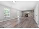 Large living room with a stone fireplace, wood floors and access to the exterior at 11203 Hemlock Rd, Hampton, GA 30228