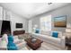 Staged living room boasts fresh gray paint, wood-look flooring, and a cozy seating arrangement at 11203 Hemlock Rd, Hampton, GA 30228