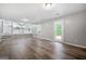 Open concept living room with wood flooring and access to the backyard at 11203 Hemlock Rd, Hampton, GA 30228