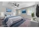 Staged main bedroom features a tray ceiling, plush carpet, and modern decor at 11203 Hemlock Rd, Hampton, GA 30228