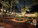 Night view of backyard landscaped with ambient lighting and mulched walking paths at 120 Tall Pine Dr, Fayetteville, GA 30214
