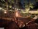 Enchanting backyard with ambient lighting, winding paths, and cozy seating around tiki torches at 120 Tall Pine Dr, Fayetteville, GA 30214