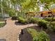 Landscaped backyard with mulched and stone walking paths, outdoor seating, and ambient lighting at 120 Tall Pine Dr, Fayetteville, GA 30214