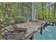 Backyard with stone patio, lounge chairs, green shed, and lush greenery, offering a private and serene outdoor retreat at 120 Tall Pine Dr, Fayetteville, GA 30214
