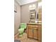 Retro bathroom featuring a unique green toilet and sink with patterned flooring at 120 Tall Pine Dr, Fayetteville, GA 30214