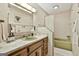Retro bathroom featuring colorful green fixtures, classic tile work, and a well-lit mirror complemented by vintage-inspired decor at 120 Tall Pine Dr, Fayetteville, GA 30214
