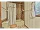 Bathroom featuring a shower-tub combination, neutral wallpaper and light colored cabinets at 120 Tall Pine Dr, Fayetteville, GA 30214