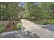Long driveway approach to the property, brick entrance with house numbers and mature trees at 120 Tall Pine Dr, Fayetteville, GA 30214