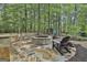 Outdoor fire pit area with stone seating and chairs, perfect for gatherings at 120 Tall Pine Dr, Fayetteville, GA 30214