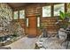 Unique foyer featuring wood paneled walls, tile floors, and a wooden front door at 120 Tall Pine Dr, Fayetteville, GA 30214