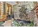 Unique foyer featuring a stone wall, indoor pond with waterfall, and greenery at 120 Tall Pine Dr, Fayetteville, GA 30214