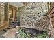 Unique foyer featuring a stone wall, indoor pond with waterfall, and greenery at 120 Tall Pine Dr, Fayetteville, GA 30214