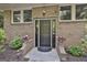Close-up of brick home's front door with sidelights, planters, and manicured landscaping at 120 Tall Pine Dr, Fayetteville, GA 30214