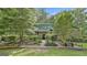 Charming brick home boasts lush landscaping, mature trees, and a welcoming front entrance at 120 Tall Pine Dr, Fayetteville, GA 30214